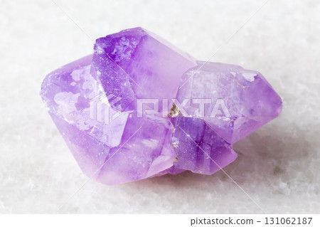 sample of raw amethyst crystals on white marble sample of raw amethyst crystals on white marble 131062187