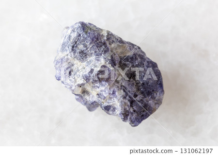 sample of rough cordierite mineral on white marble 131062197