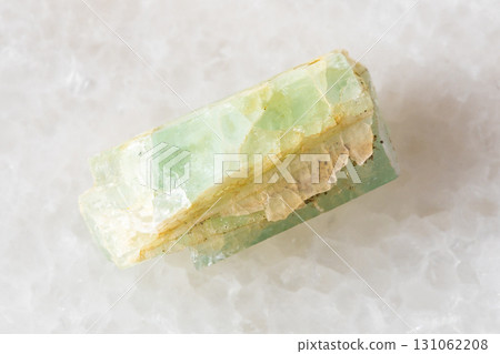 sample of raw green beryl crystal on white marble sample of raw green beryl crystal on white marble 131062208