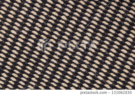 Black and beige woven fabric texture close up 131062830