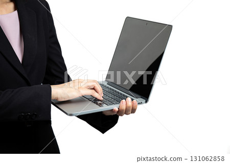 Businesswoman in black suit typing on laptop isolated on white background, concept of online work, digital technology, remote office, modern business, professional career, internet connection, and 131062858