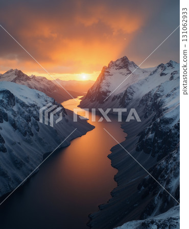 A beautiful northern landscape at sunset, with snow-covered mountains and a lake. 131062933