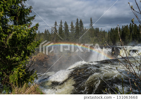 Ristafallet Waterfall in Sweden with a rainbow in the sky. Ristafallet Waterfall in Sweden with a rainbow in the sky. 131063668