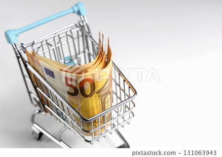 Shopping cart filled with euro bills Shopping cart filled with euro bills 131063943
