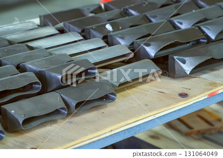 Metal ice cream sticks molds for woodwork machines on shelves on factory. Metal ice cream sticks molds for woodwork machines on shelves on factory. 131064049