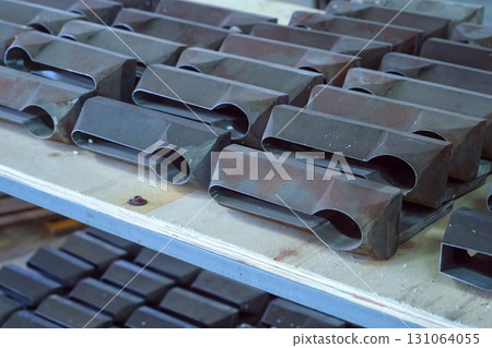 Metal molds for woodwork machines on shelves in industrial manufacturing factory Metal molds for woodwork machines on shelves in industrial manufacturing factory 131064055