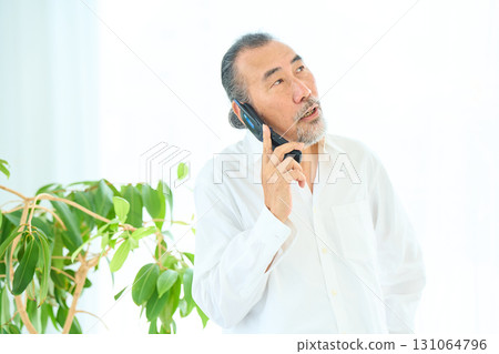 Seniors making calls on flip phones 131064796