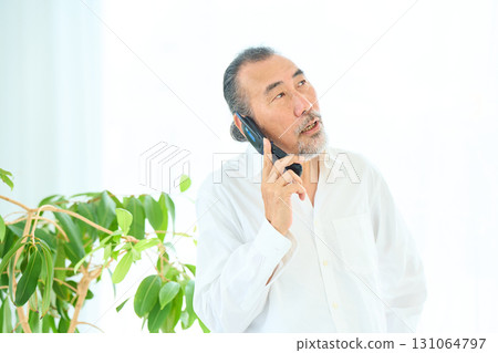 老人用翻蓋手機打電話 131064797