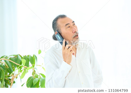 Seniors making calls on flip phones 131064799