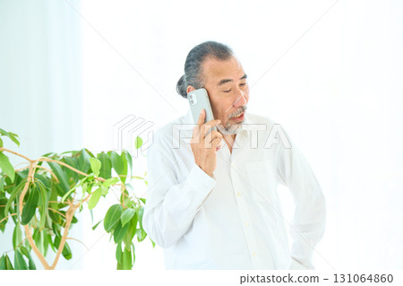 Seniors making a phone call on a smartphone 131064860