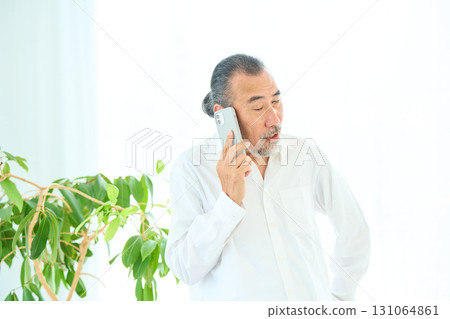 Seniors making a phone call on a smartphone Seniors making a phone call on a smartphone 131064861