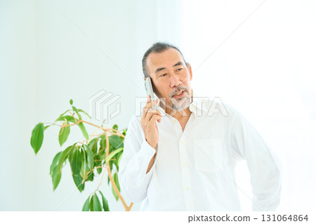 Seniors making a phone call on a smartphone 131064864