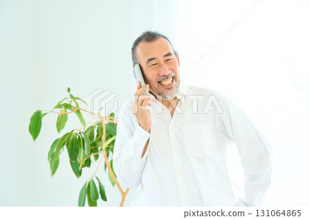 Seniors making a phone call on a smartphone 131064865