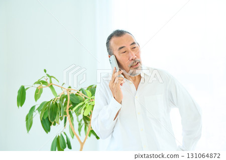 Seniors making a phone call on a smartphone 131064872