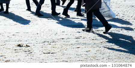 Image of people busily passing through a winter intersection Image of people busily passing through a winter intersection 131064874