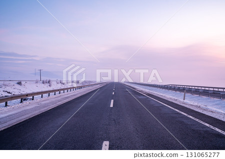 Empty Highway in Winter Landscape at Sunset or Sunrise 131065277