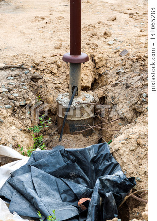 Construction Pit Featuring Newly Installed Urban Streetlight Pole, Highlighting Modern Urban Infrastructure Development and Safety Enhancements Construction Pit Featuring Newly Installed Urban Streetlight Pole, Highlighting Modern Urban Infrastructure Development and Safety Enhancements 131065283