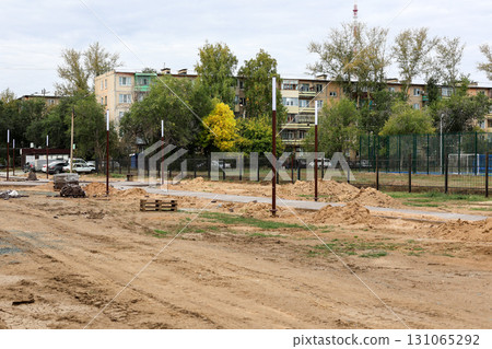 Construction of a New Urban Park: Leveling the Ground and Laying New Sidewalks for a Vibrant Community Space 131065292