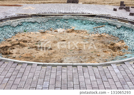 Round Construction Pit on Sidewalk in Newly Developing Park, Showcasing Urban Development and Infrastructure Improvements for Community Spaces 131065293