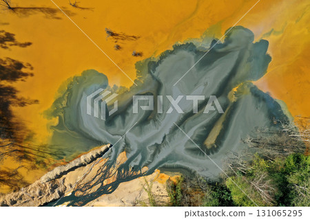 Aerial view of a big waste decanting lake, tailing pond. Mining residual waters discharged from copper mine Aerial view of a big waste decanting lake, tailing pond. Mining residual waters discharged from copper mine 131065295
