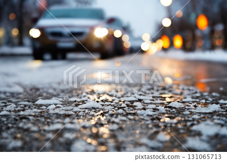 a car on the background of a winter snow-covered road with ice, the concept of traffic safety on a slippery road 131065713