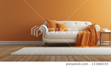 Modern living room with white sofa, orange pillows, and matching throw blanket against orange wall, with small wooden side table and books 131066335