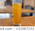 Mango juice in a tall glass on the table 131067152