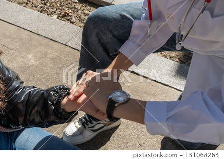 Doctor comforting patient by holding hands, offering support and empathy after bad news Doctor comforting patient by holding hands, offering support and empathy after bad news 131068263