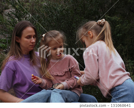 mother with daughter outside doing makeup having fun 131068641