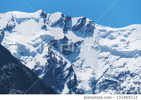 Snow-capped peaks with lots of snow and dangerous avalanches Snow-capped peaks with lots of snow and dangerous avalanches 131069112
