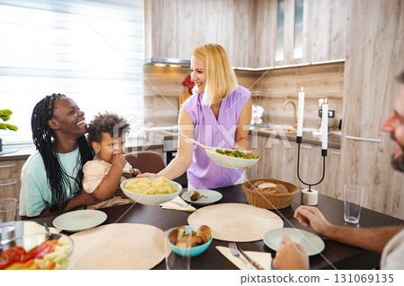 Family gathers in a cozy kitchen for a meal Family gathers in a cozy kitchen for a meal 131069135
