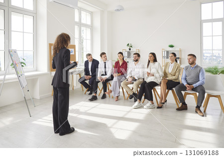 Businesswoman Hosting Meeting With Team In Office Businesswoman Hosting Meeting With Team In Office 131069188