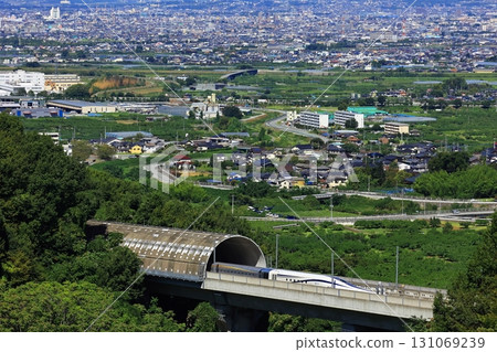 The Linear Shinkansen emerging from the tunnel and the view of the Kofu Basin The Linear Shinkansen emerging from the tunnel and the view of the Kofu Basin 131069239