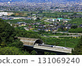 The Linear Shinkansen emerging from the tunnel and the view of the Kofu Basin 131069240