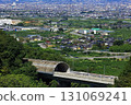 The Linear Shinkansen emerging from the tunnel and the view of the Kofu Basin 131069241
