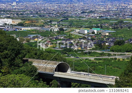 The Linear Shinkansen emerging from the tunnel and the view of the Kofu Basin 131069241