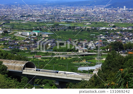 The Linear Shinkansen emerging from the tunnel and the view of the Kofu Basin The Linear Shinkansen emerging from the tunnel and the view of the Kofu Basin 131069242