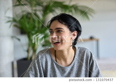 A close up portrait of a young businesswoman engaged in a professional meeting, confidently discussing ideas and strategies with her colleagues A close up portrait of a young businesswoman engaged in a professional meeting, confidently discussing ideas and strategies with her colleagues 131070437