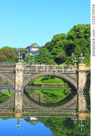 View of the main gate stone bridge and Fushimi Turret in the Imperial Palace Outer Gardens, Chiyoda Ward, Tokyo 131070458