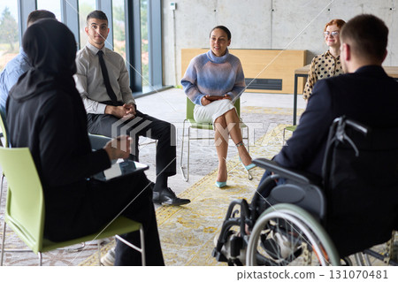 Corporate business team meeting with a manager or coach. Group of happy diverse, multiracial people sitting in a circle Corporate business team meeting with a manager or coach. Group of happy diverse, multiracial people sitting in a circle 131070481