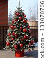 Christmas tree with gifts and decorations for New Year's holidays in the yard, winter season 131070706