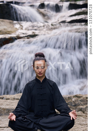 A woman sits in lotus pose, practicing yoga and tai chi under a tropical waterfall, meditating with calm strength and mindfulness, fully connected to the energy of nature, tranquility and inner A woman sits in lotus pose, practicing yoga and tai chi under a tropical waterfall, meditating with calm strength and mindfulness, fully connected to the energy of nature, tranquility and inner 131070728
