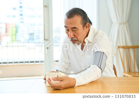 Senior measuring blood pressure 131070833