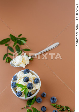 Close-up of cottage cheese with blue berries and a sprig of mint Close-up of cottage cheese with blue berries and a sprig of mint 131072871
