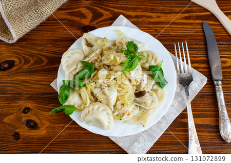 Hot dumplings with onions and fresh herbs Hot dumplings with onions and fresh herbs 131072899