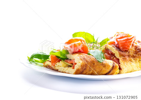 Homemade omelet with salmon pieces and green leaves Homemade omelet with salmon pieces and green leaves 131072905