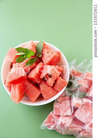 Summer concept with fresh and frozen watermelon fruit cubes Summer concept with fresh and frozen watermelon fruit cubes 131072911