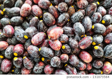 Ripe red buah dabai fruit is also known as Borneo olive from tropical jungle is sold in market stalls in Sarawak Ripe red buah dabai fruit is also known as Borneo olive from tropical jungle is sold in market stalls in Sarawak 131073564