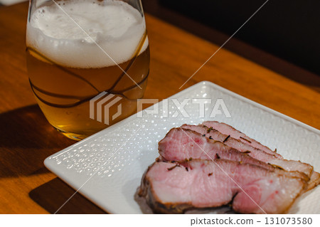Beer and roast pork dinner 131073580