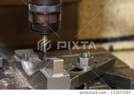 The CNC milling machine cutting the press die parts with solid ball nose end mill tool. The CNC milling machine cutting the press die parts with solid ball nose end mill tool. 131073585